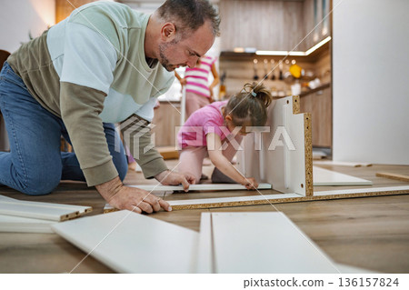 Family bonding through DIY furniture assembly in a cozy kitchen Family bonding through DIY furniture assembly in a cozy kitchen 136157824