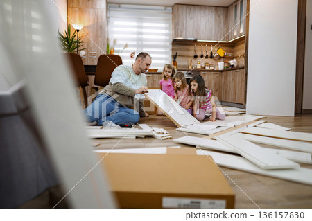 Family bonding while assembling furniture in a cozy home Family bonding while assembling furniture in a cozy home 136157830