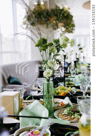 Green floral centerpiece on elegant banquet table with city view, natural light Green floral centerpiece on elegant banquet table with city view, natural light 136158192