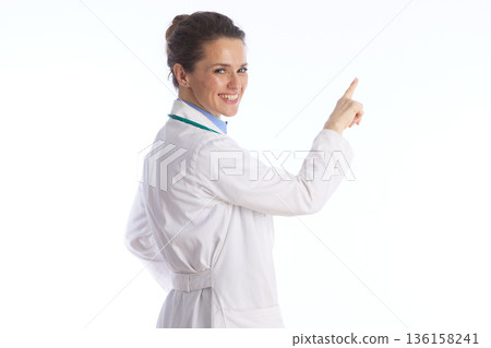 Friendly Doctor Looking Back and Pointing to Health Information 136158241