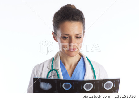 Female Doctor Analyzing Multiple X-ray Films 136158336
