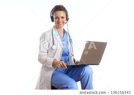 Remote Doctor Typing on Laptop during Telehealth Consultation 136158341