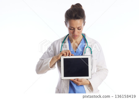 Focused Doctor Reviewing Medical Records on Tablet Focused Doctor Reviewing Medical Records on Tablet 136158419