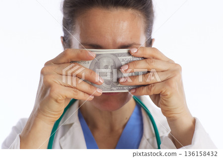 Healthcare Professional Covering Mouth with Money Healthcare Professional Covering Mouth with Money 136158432