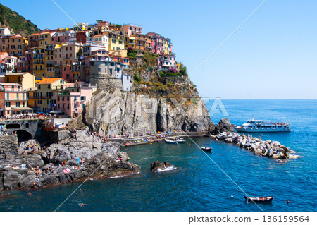 Multicolor houses on mountain. Manarola Italian village Cinque Terre Liguria Italy. Summer sea 136159564