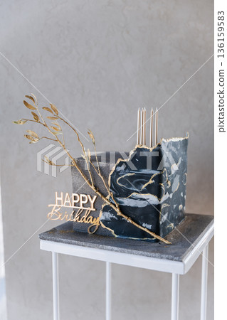 Luxury black marble birthday cake with gold details and Happy Birthday topper, copy space 136159583