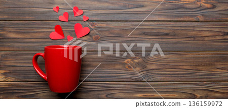 red cup on colored background, splashes of red little hearts, top view with copy space 136159972