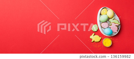 Colorful easter cookies in basket with Multi colors Easter eggs on colored background . Pastel color Easter eggs. holiday concept with copy space Colorful easter cookies in basket with Multi colors Easter eggs on colored background . Pastel color Easter eggs. holiday concept with copy space 136159982