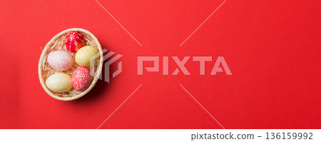 Multi colors Easter eggs in the woven basket on colored background . Pastel color Easter eggs. holiday concept with copy space Multi colors Easter eggs in the woven basket on colored background . Pastel color Easter eggs. holiday concept with copy space 136159992