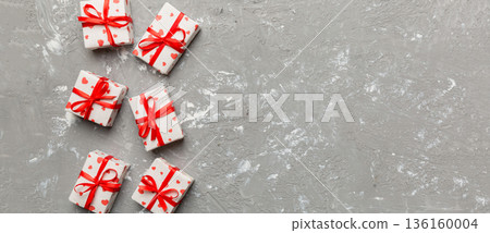 Valentine day composition: red gift box with bow and heart. Christmas present. View from above. Space for text. Holday greeting card 136160004