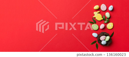 Colorful easter eggs in nest on table background with copy space top view 136160023