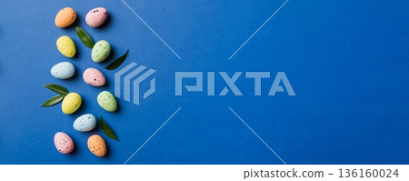Happy Easter concept. Preparation for holiday. Easter eggs on colored background. flat lay top view copy space banner 136160024