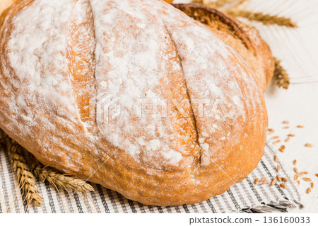 Homemade natural breads. Different kinds of fresh bread as background, perspective view with copy space Homemade natural breads. Different kinds of fresh bread as background, perspective view with copy space 136160033