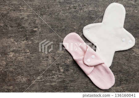 Eco-friendly reusable fabric women's pads. set of colorful bright reusable menstrual pads. zero waste woman periods concept top view with copy space Eco-friendly reusable fabric women's pads. set of colorful bright reusable menstrual pads. zero waste woman periods concept top view with copy space 136160041
