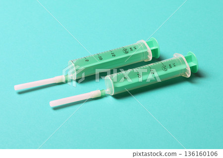 Top view of medical syringes on colorful background with copy space. Injection equipment concept Top view of medical syringes on colorful background with copy space. Injection equipment concept 136160106
