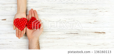 Two hands with a heart on a white background. Valentine's Day copt space Two hands with a heart on a white background. Valentine's Day copt space 136160113