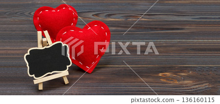 Red heart and small blackboard with copy space on a black background. Valentine's day composition Red heart and small blackboard with copy space on a black background. Valentine's day composition 136160115