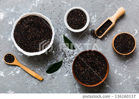 quinoa seeds in bowl and spoon on colored background. Healthy kinwa in small bowl. Healthy superfood quinoa seeds in bowl and spoon on colored background. Healthy kinwa in small bowl. Healthy superfood 136160137