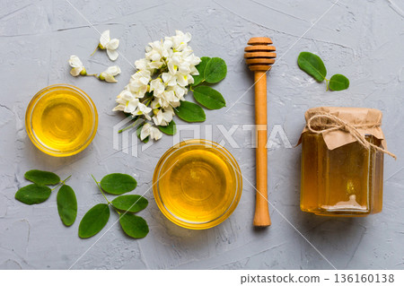 honey jar with acacia flowers and leaves. fresh honey top view flat lay honey jar with acacia flowers and leaves. fresh honey top view flat lay 136160138