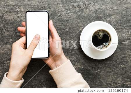 Top view of woman hands holding smart phone with blank copy space screen for your text message or information content. woman hand using phone white screen on top view 136160174
