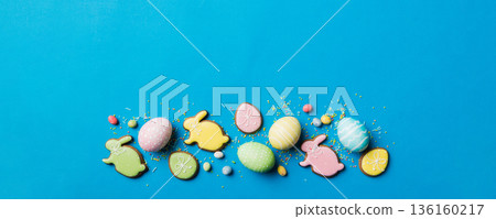 holiday preparation Multi colors Easter eggs with cookies on colored background . Pastel color Easter eggs. holiday concept with copy space holiday preparation Multi colors Easter eggs with cookies on colored background . Pastel color Easter eggs. holiday concept with copy space 136160217