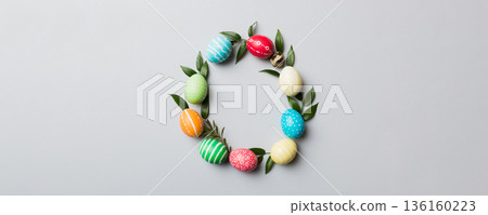 round frame Multi colors Easter eggs on colored background . Pastel color Easter eggs holiday concept with empty space for you design 136160223