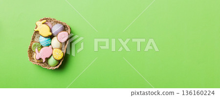 Multi colors Easter eggs in the woven basket on colored background . Pastel color Easter eggs. holiday concept with copy space Multi colors Easter eggs in the woven basket on colored background . Pastel color Easter eggs. holiday concept with copy space 136160224