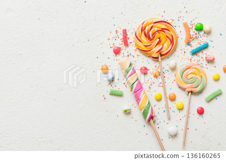 Tasty appetizing Party Accessories Happy Birthday Sweet. Different types of candies on colored background, copy space. Colorful birthday party background 136160265