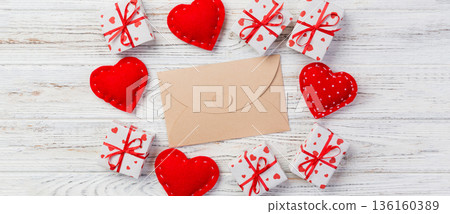Envelope Mail with Red Heart and gift box over White Wooden Background. Valentine Day Card, Love or Wedding Greeting Concept Envelope Mail with Red Heart and gift box over White Wooden Background. Valentine Day Card, Love or Wedding Greeting Concept 136160389