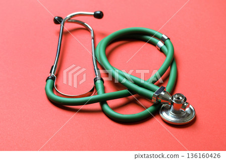 Top view of green medical stethoscope on colorful background with copy space. Medicine equipment concept 136160426