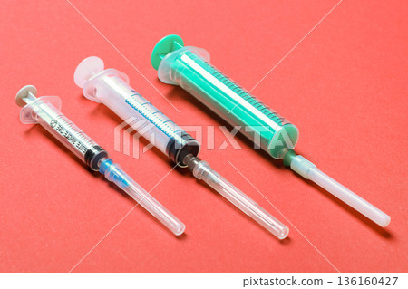 Top view of syringes in a row for medical injection on colorful background with copy space. Health and vaccination concept 136160427