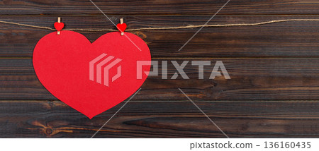 Big love red heart hanging on wooden texture background, valentines day card concept Big love red heart hanging on wooden texture background, valentines day card concept 136160435