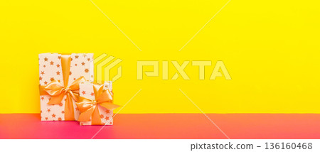 holiday paper present tied yellow ribbon bow top view with copy space. Flat lay holiday background. Birthday or christmas present. Christmas gift box concept with copy space holiday paper present tied yellow ribbon bow top view with copy space. Flat lay holiday background. Birthday or christmas present. Christmas gift box concept with copy space 136160468