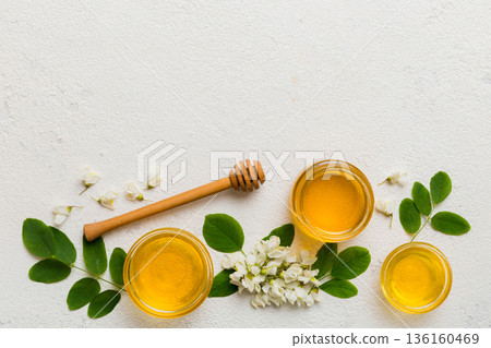 honey jar with acacia flowers and leaves. fresh honey top view flat lay 136160469