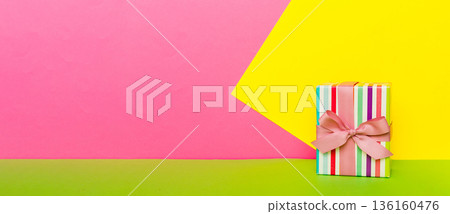 holiday paper present tied pink ribbon bow top view with copy space. Flat lay holiday background. Birthday or christmas present. Christmas gift box concept with copy space 136160476
