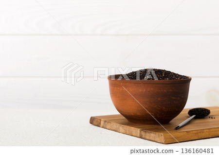 quinoa seeds in bowl on colored background. Healthy kinwa in small bowl. Healthy superfood 136160481