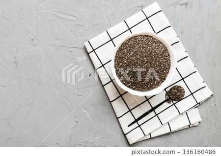 Chia seeds in bowl and spoon on colored background. Healthy Salvia hispanica in small bowl. Healthy superfood 136160486