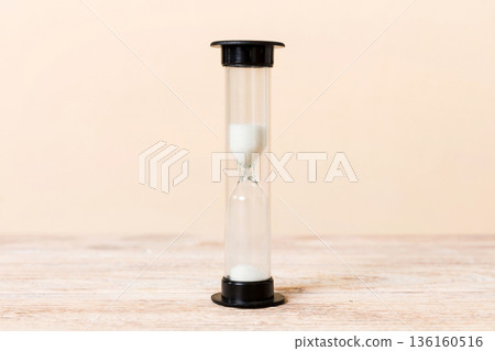 hourglass on the table, sand clock as time passing concept for business deadline, copy space hourglass on the table, sand clock as time passing concept for business deadline, copy space 136160516