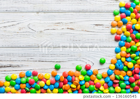 Mixed collection of colorful candy, on colored background. Flat lay, top view. frame of colorful chocolate coated candy 136160545