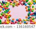 Mixed collection of colorful candy, on colored background. Flat lay, top view. frame of colorful chocolate coated candy 136160547