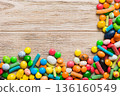 Mixed collection of colorful candy, on colored background. Flat lay, top view. frame of colorful chocolate coated candy 136160549
