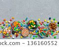 different colored round candy in bowl and jars. Top view of large variety sweets and candies with copy space 136160552