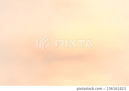 A scene of only the pale orange sky at dusk A scene of only the pale orange sky at dusk 136161823