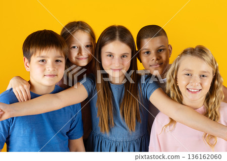 Closeup shot of happy preteen children taking selfie together on yellow background Closeup shot of happy preteen children taking selfie together on yellow background 136162060