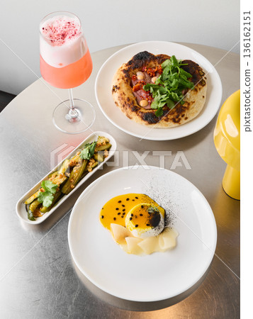 Elevated brunch trio with hollandaise and pink cocktail Elevated brunch trio with hollandaise and pink cocktail 136162151