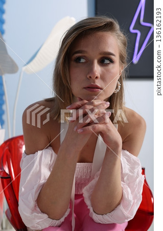 Thoughtful girl resting, Young lady with white hat in studio setting Thoughtful girl resting, Young lady with white hat in studio setting 136162193