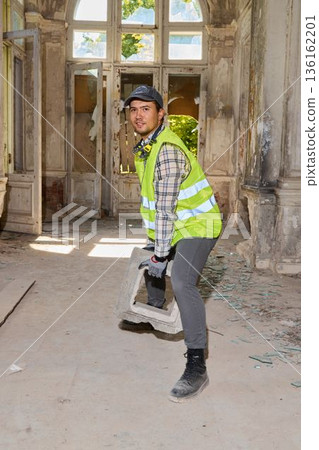 Heritage restoration contractor clearing debris with jackhammer Heritage restoration contractor clearing debris with jackhammer 136162201
