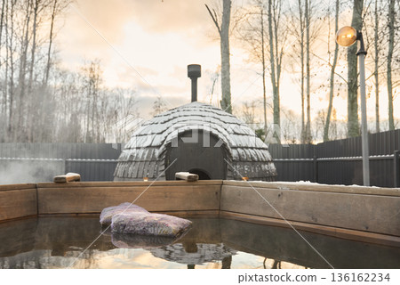 Exclusive outdoor hot spring with ambient lighting during sunset Exclusive outdoor hot spring with ambient lighting during sunset 136162234