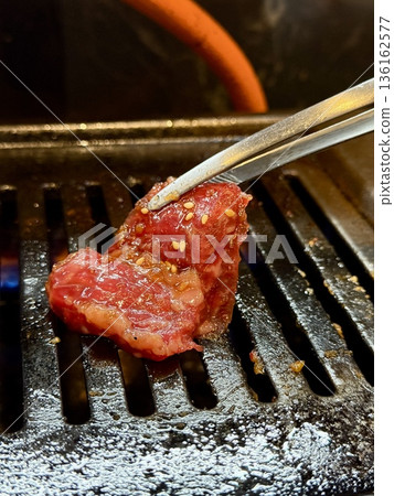 Close-up of barbecued beef. Marinated lean meat at a yakiniku restaurant. Close-up of barbecued beef. Marinated lean meat at a yakiniku restaurant. 136162577