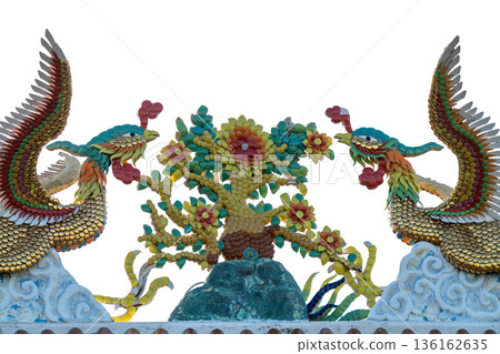 Traditional Chinese temple roof decoration featuring colorful mosaic phoenix birds and floral tree isolated on white. Detailed ceramic shard craftsmanship representing oriental myth and culture. Traditional Chinese temple roof decoration featuring colorful mosaic phoenix birds and floral tree isolated on white. Detailed ceramic shard craftsmanship representing oriental myth and culture. 136162635